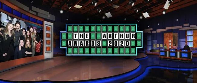 People celebrating at The Arthur Awards 2020, music industry event, on a stage with large digital display, lively atmosphere,