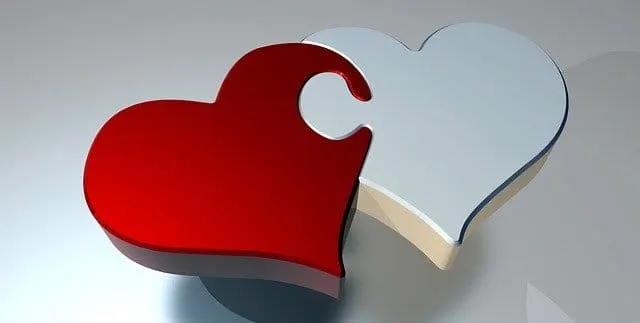 Puzzle piece heart with red and white colors symbolizing love and connection, representing themes of relationships, emotional