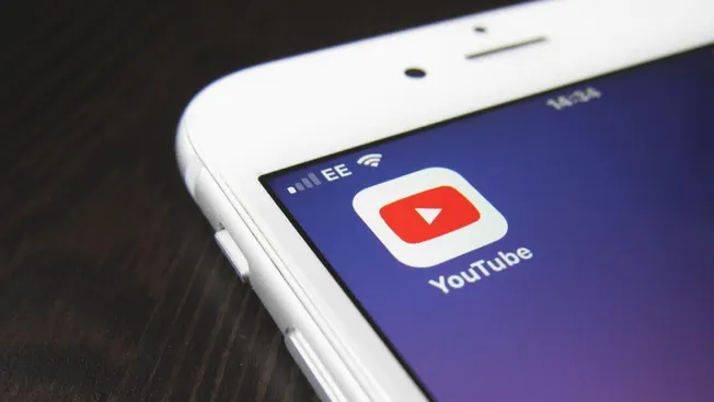 YouTube app on smartphone screen, digital video streaming, mobile device, online video platform, content creator, multimedia