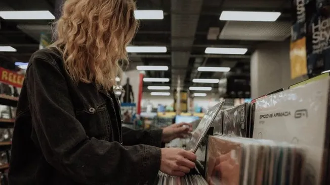 Home shopping vinyl records music store collection music enthusiasts browsing records in store.