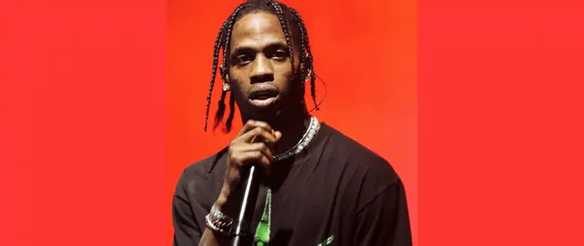 Viral rapper Lil Yachty performing with a microphone on stage against a vibrant red background, highlighting music industry t