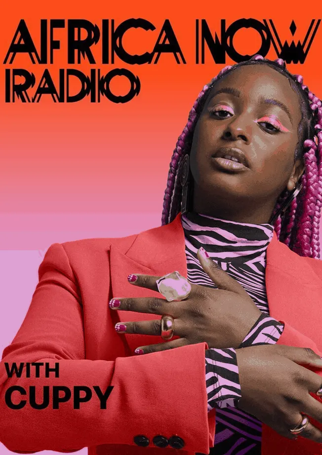 Africa now radio show host with guppy featuring bold fashion and vibrant pink braids, promoting African music and culture on