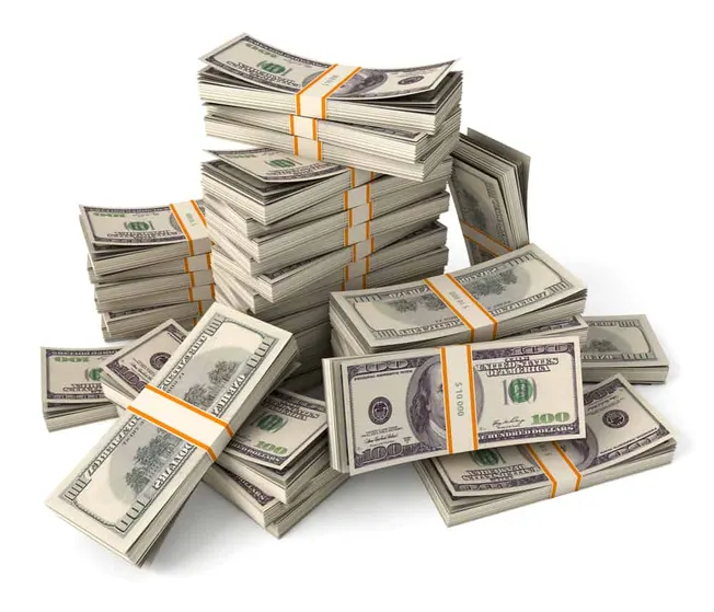 Stacks of US hundred-dollar bills arranged in bundles and scattered on a white background.