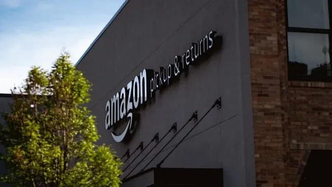 Amazon delivery center with pickup and returns signage, modern logistics facility, Amazon warehouse operations, e-commerce fu
