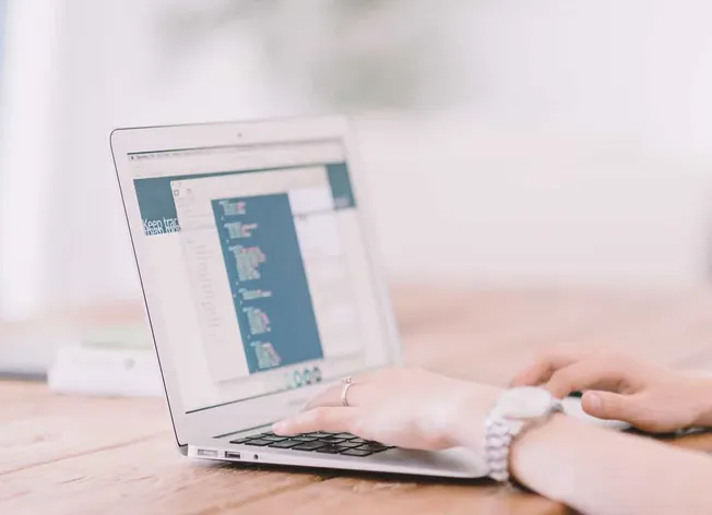 Coding on laptop with digital interface, technology and programming, modern workspace, developer working on software developm