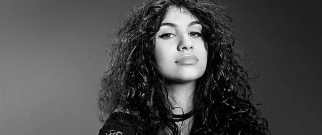 Bold woman with curly hair in black and white portrait, representing music industry, artist empowerment, or influencer in the
