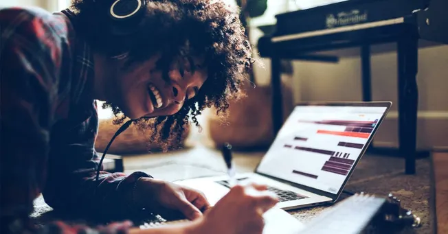 Laptop with music editing software, home music studio setup, mixing music at home, digital audio workstation, music productio