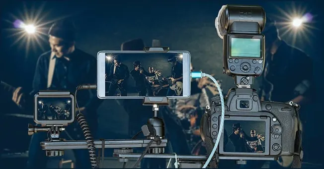 Recording professional music performances with DSLR camera and lighting equipment at a live concert.