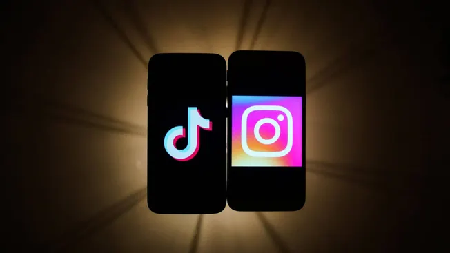 TikTok and Instagram app logos displayed on smartphones with backlighting, representing social media platforms for music and