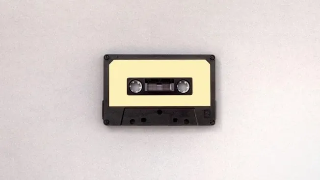 Vintage cassette tape on a plain background, representing music, audio, and media storage.