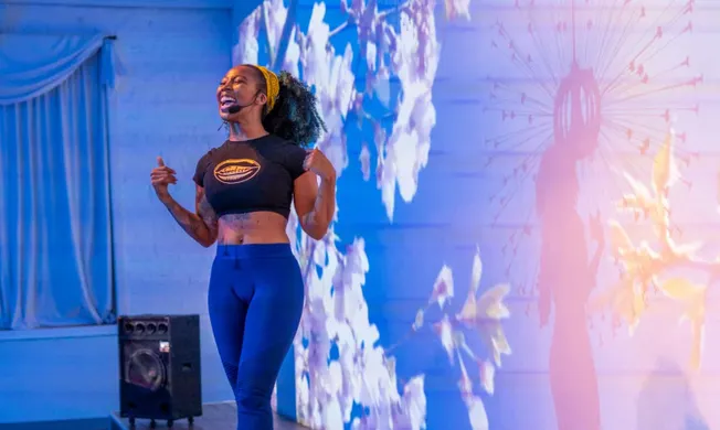 Vibrant speaker at Hypebot industry event, delivering a motivational talk to music and entertainment professionals in a moder