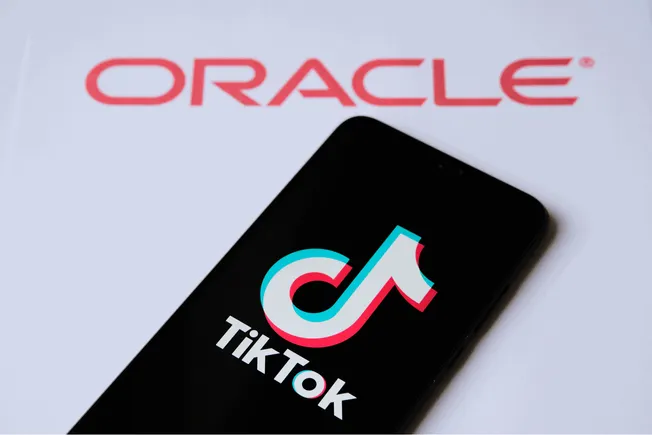 Oracle logo and TikTok app on smartphone screen with Hypebot branding, representing social media marketing, digital entertain