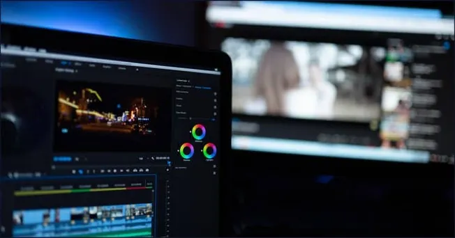 A breathtaking shot of a digital editing workspace featuring multiple screens with video editing software, color correction t