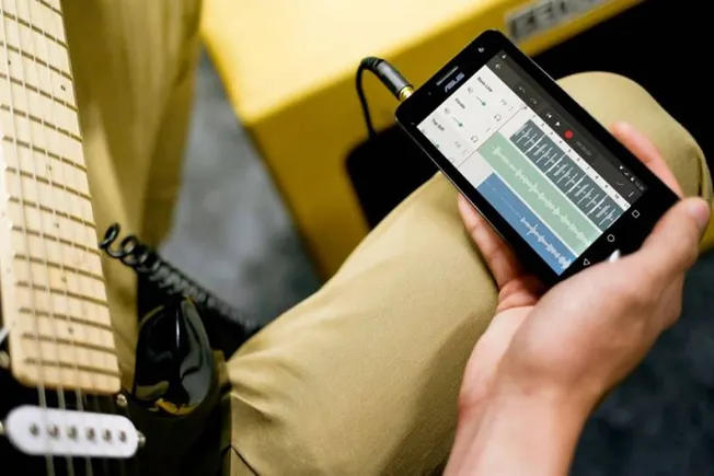 Music production app on smartphone for creating beats and music tracks.