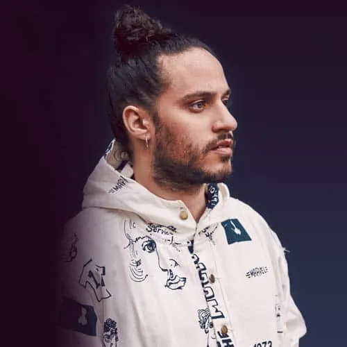 High fashion male model with a top knot hairstyle wearing a graphic hoodie, studio shot, urban streetwear style, dark backgro