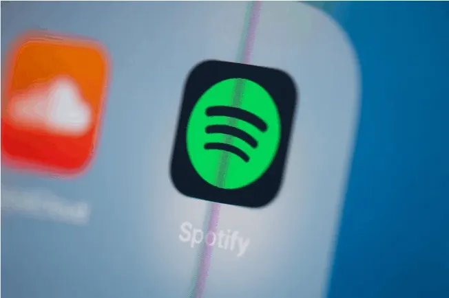 Spotify app icon on a smartphone screen, digital music streaming, music technology, popular music app, branding, music listen