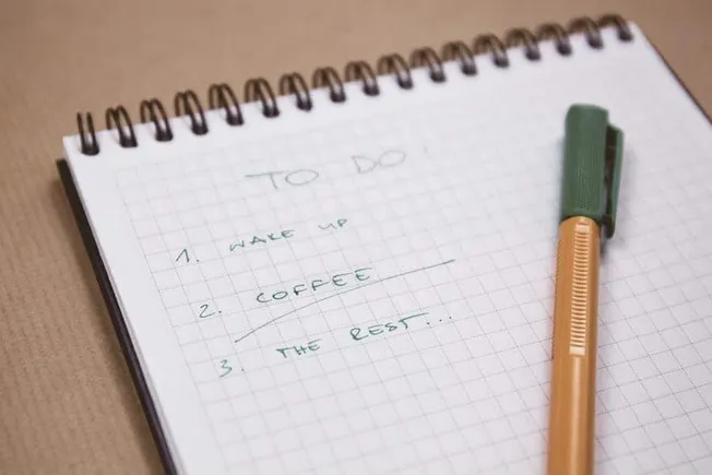 To-do list for productivity and organization with handwritten notes on a spiral notepad and colorful pen for planning and dai