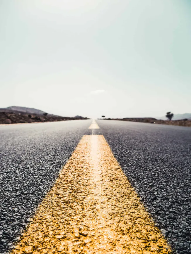 Open road with yellow centerline stretching into the distance, symbolizing journey and exploration, ideal for music industry