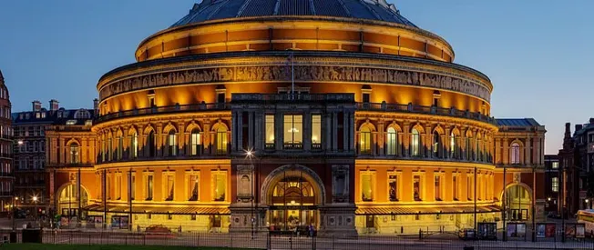 Hypebot article feature on historic theater illuminated at twilight, showcasing classic architecture and vibrant lighting in