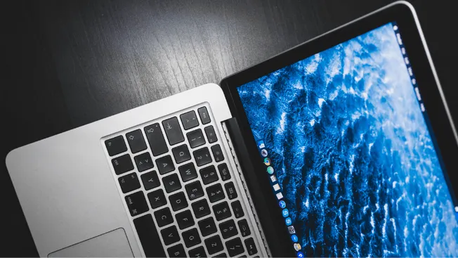 Close-up of a laptop with a digital ocean wallpaper on the screen, showcasing technology and digital innovation.