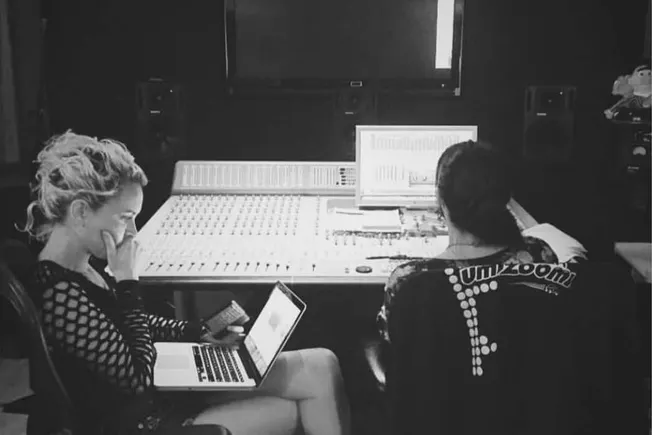 Recording studio musicians working on music production and mixing with laptops and audio equipment for music industry, profes