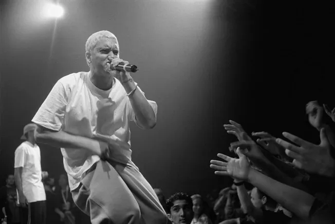 Microphone performer engaging with audience at concert black and white image.