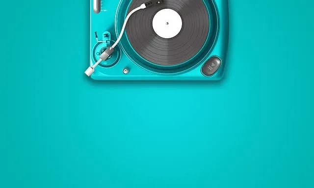 Turntable with headphones and vinyl record on vibrant blue background, showcasing music production and DJ equipment for a mus