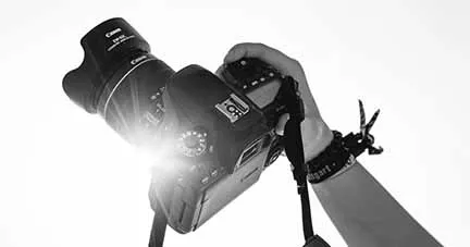 High-quality professional digital camera being operated, ideal for music industry event coverage or media production.