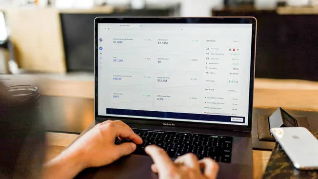 Financial dashboard displaying revenue metrics on a MacBook Pro for music industry analytics.