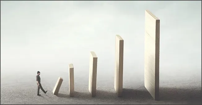 Innovative business growth concept with a person walking towards increasing wooden blocks representing progress and success i