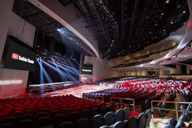 Youtube theater concert venue with stage lighting and large screens for live performances and digital content showcasing mode