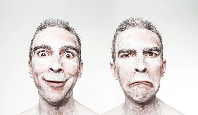 Unhappy man with disgusted face on the right and amused face on the left, showcasing contrasting emotions in a studio portrai