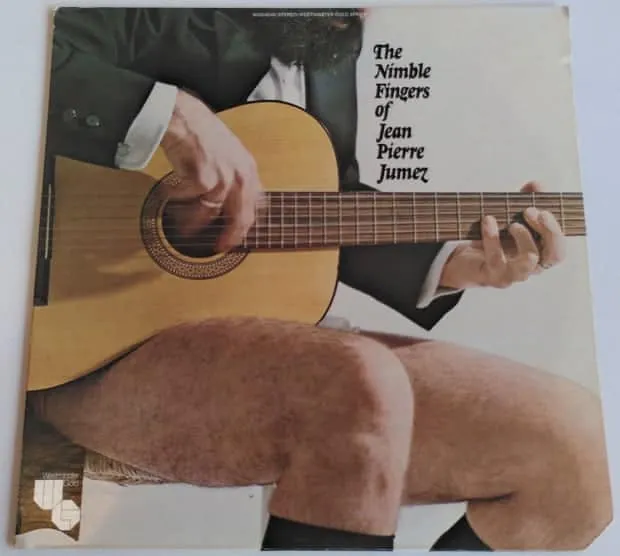 Guitarist playing acoustic guitar, close-up of hands and legs, album cover of "The Nimble Fingers of Jean Pierre Jumez" with