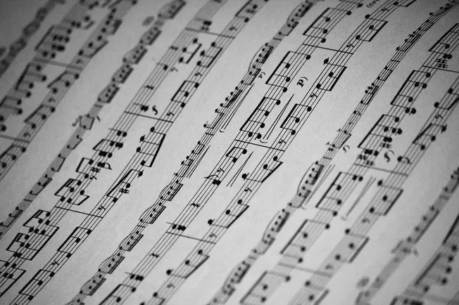 Music sheet with musical notes and notation, close-up of printed musical score for composition or performance.