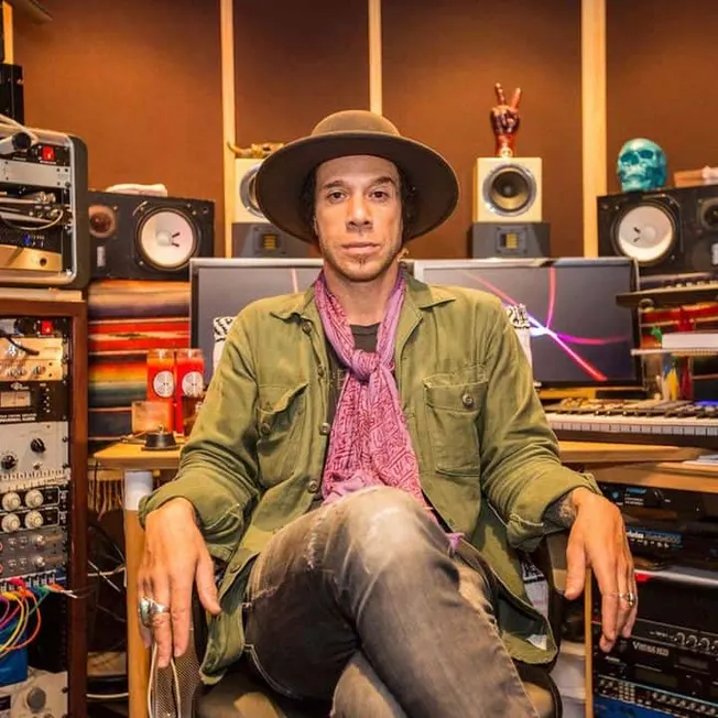 Creative music producer in a professional recording studio with audio equipment, studio monitors, and musical gear, showcasin