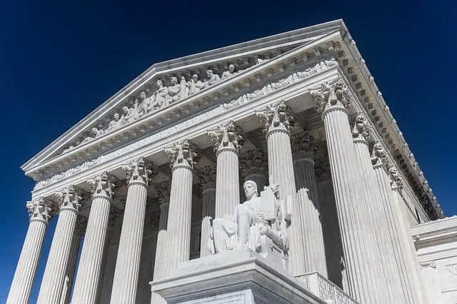 Ancient Greek-style government building with tall columns and intricate sculptures, symbolizing democracy and classical archi