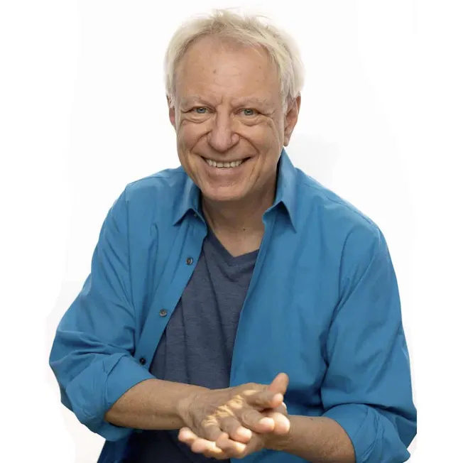 Smiling mature man in casual blue shirt clapping with a friendly expression, portrait for media, positivity, happiness, and p