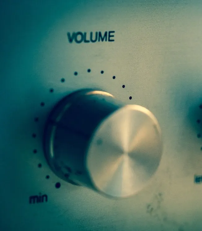Adjustable volume control knob on audio equipment, close-up shot.