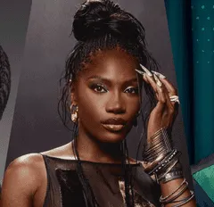 Beauty portrait of a confident woman with styled hair and bold accessories, showcasing modern fashion and makeup for a music