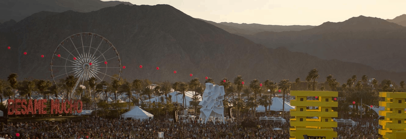 Ferris wheel and festival crowd at outdoor music event showcasing popular music industry trends for 2023.