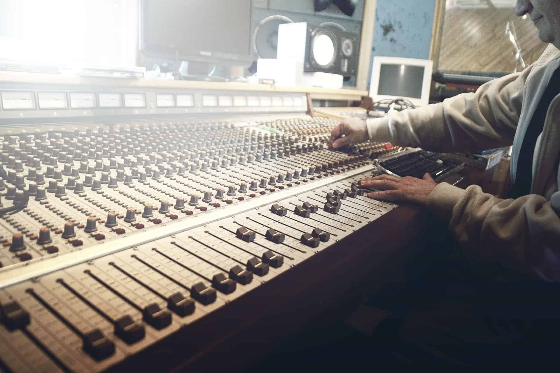 Mixing console in music studio for audio production and sound engineering.