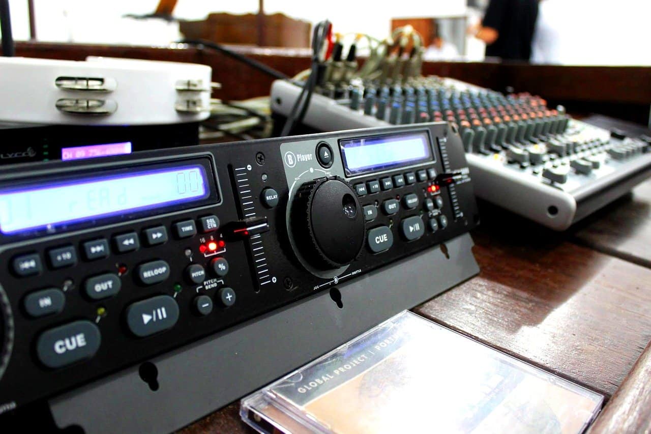 Professional DJ mixing equipment with digital controllers and sound mixer for music production and live performances.