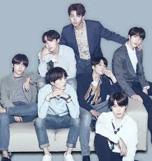 Cute boy band members sitting on couch, stylish clothing, indoor photoshoot, music group, youth fashion, Hypebot.