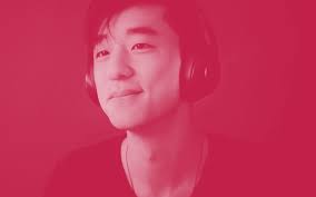 A young man wearing headphones with a relaxed expression, representing music listening or audio production in a digital environment.