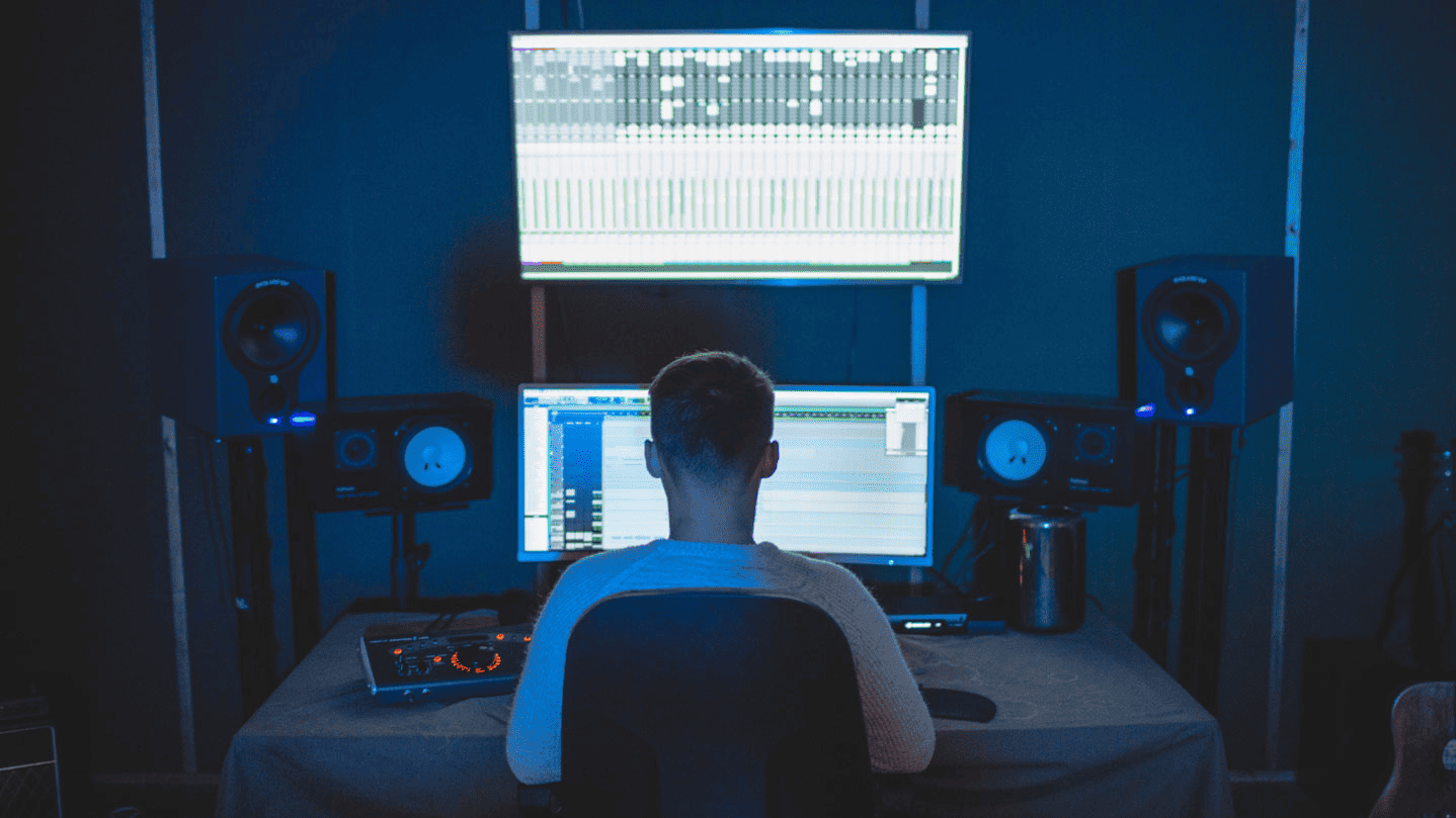 Music production studio with digital audio workstation and speakers, focusing on electronic music mixing and mastering, professional sound engineering environment, music technology.