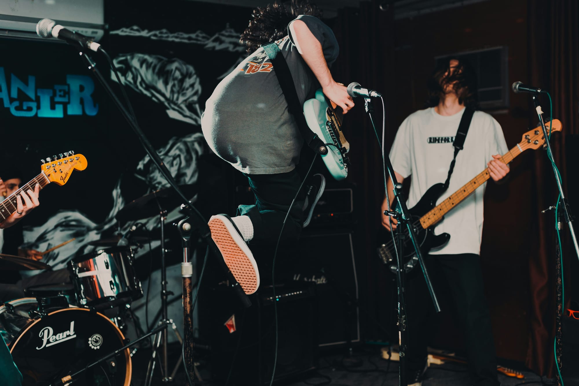 People with musical instruments jumping on stage