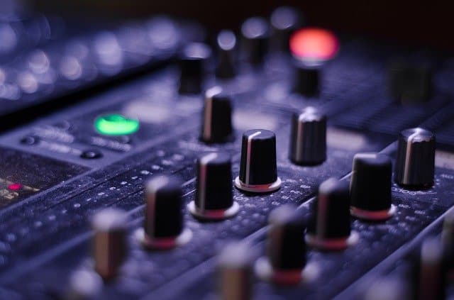 High-quality DJ mixing console with colorful knobs and controls, ideal for music production and live performances, representing audio mixing, music technology, and event setup.