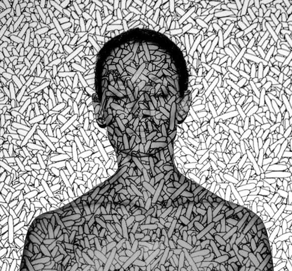 Silhouette of a person made from scattered pills or capsules, symbolizing medication or pharmaceutical themes.