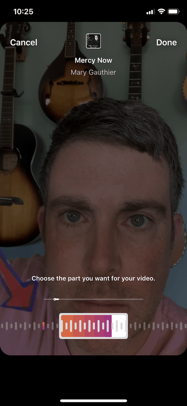 Harmonizing music video editing on mobile app with guitar wall background.