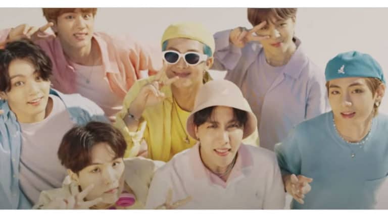 Youth group of diverse friends making peace signs, wearing colorful casual clothes and accessories, enjoying fun moments together in a bright, cheerful setting.